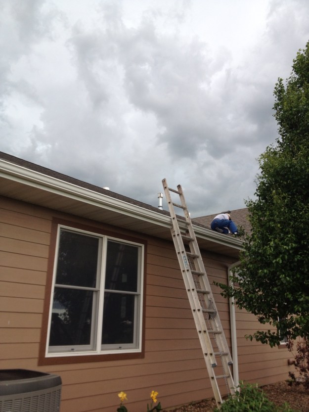 Up on the roof!?! Mr. Farmer is trying to find the small leak in my closet. Thankfully it was just a beautiful cloud formation that wasn't a storm.